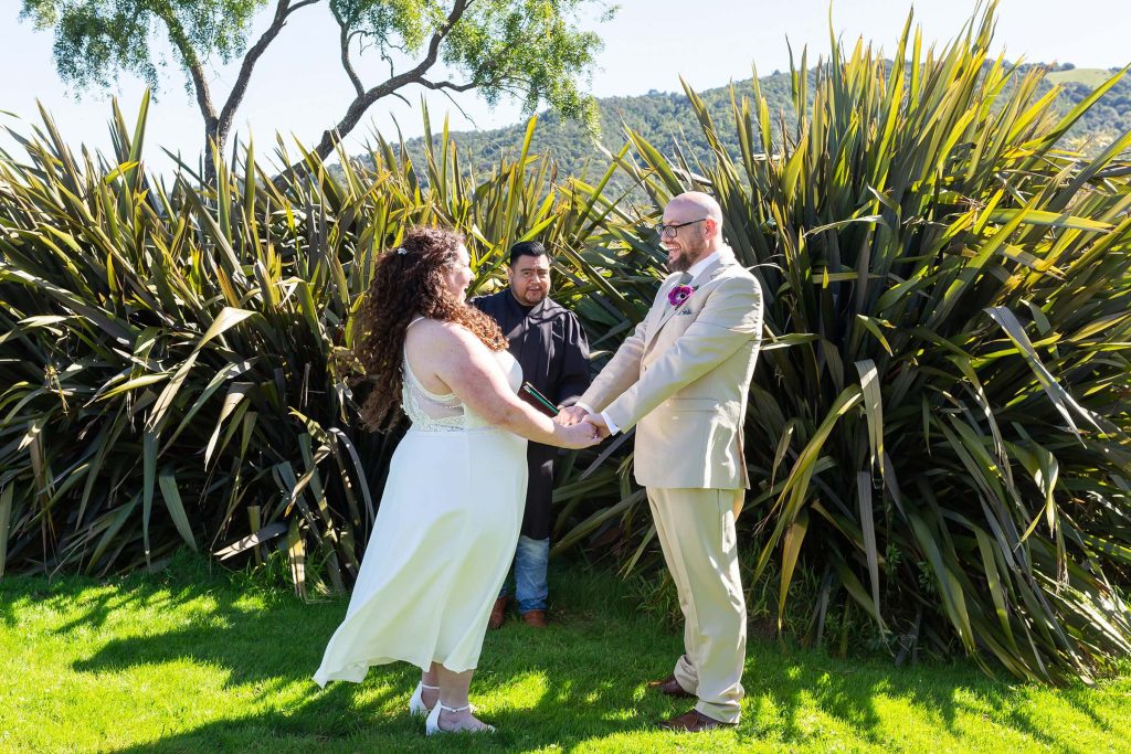 marin civic center wedding photo with bride and groom holding hands at ceremony outdoor location